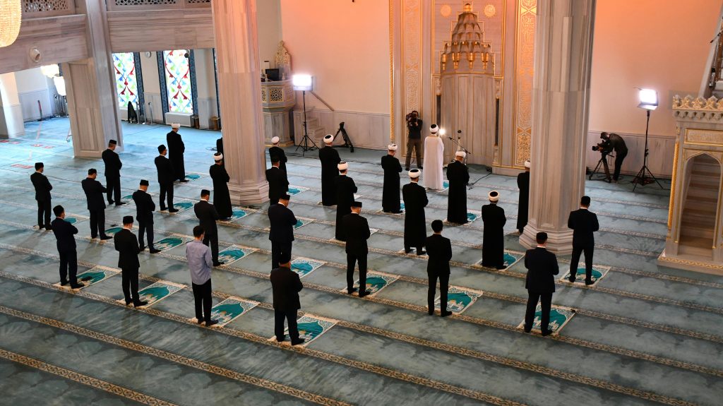 Muslim praying and reviewing halal investment options in the USA.